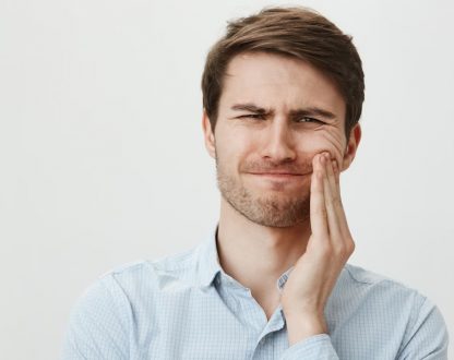 Men is suffering from tooth ache