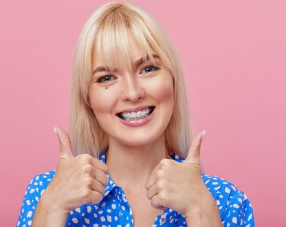 Cute girl waring braces and smiling